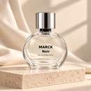 MARCK Noir 50 ml — líquido claro sobre pedra com tecido bege
